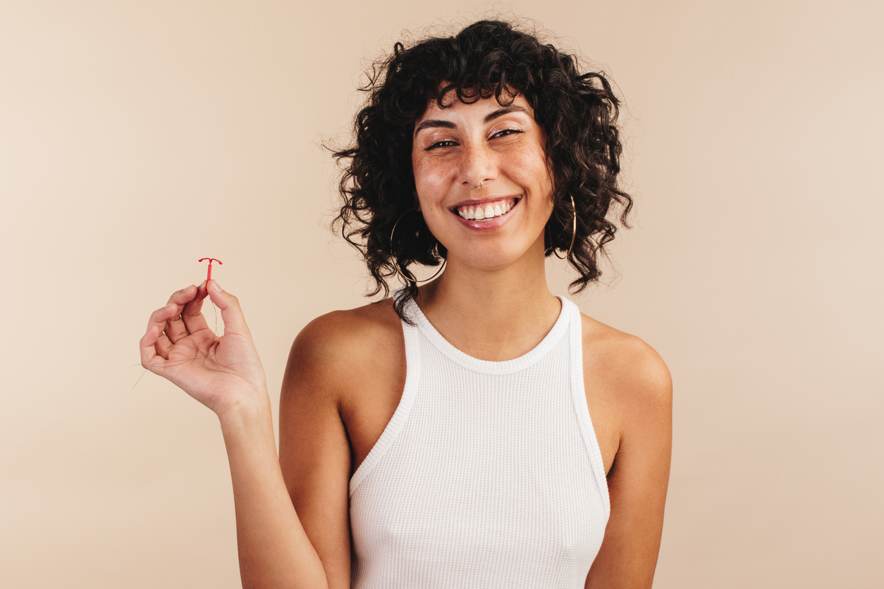 young woman holding an iud