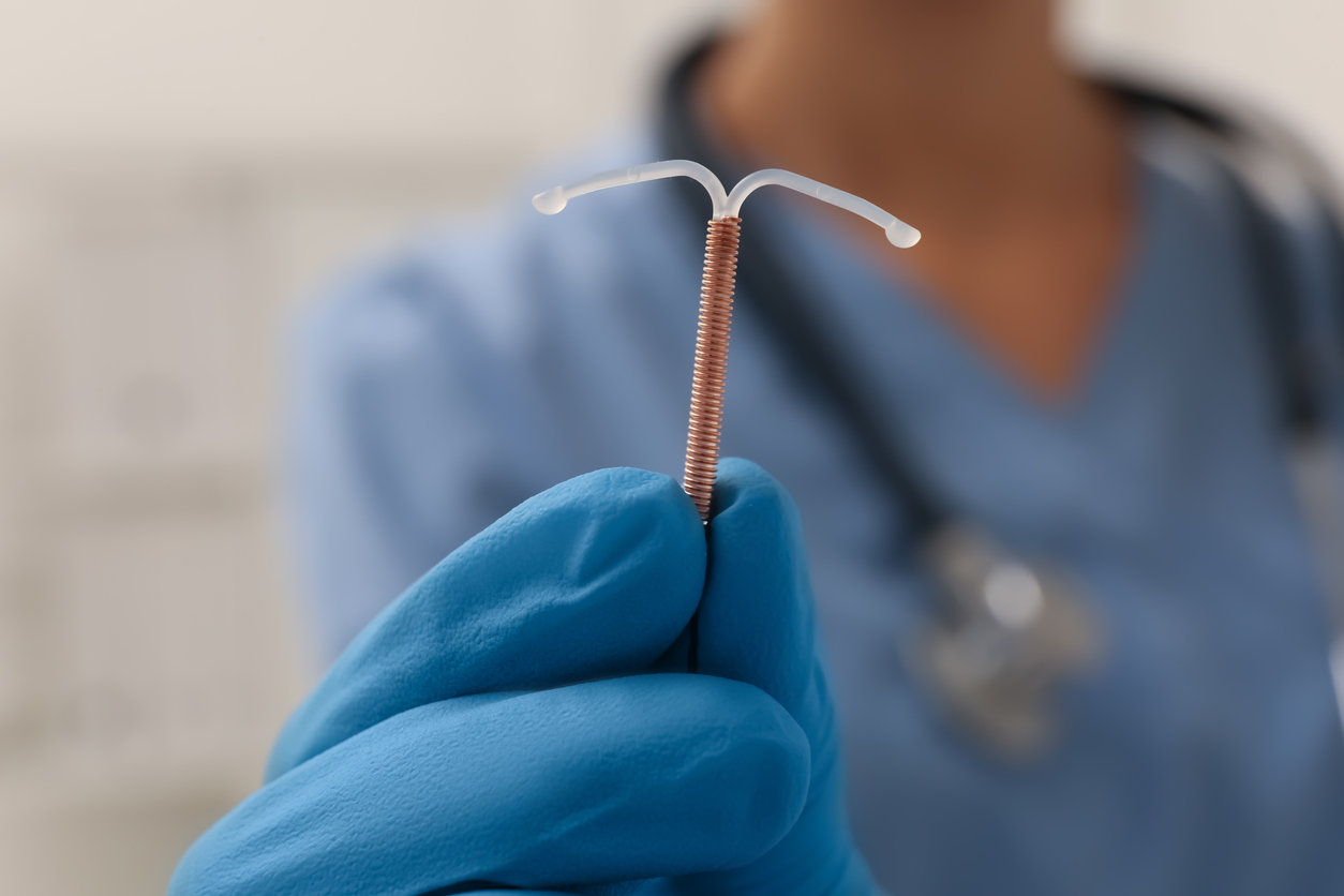 doctor holding a copper iud