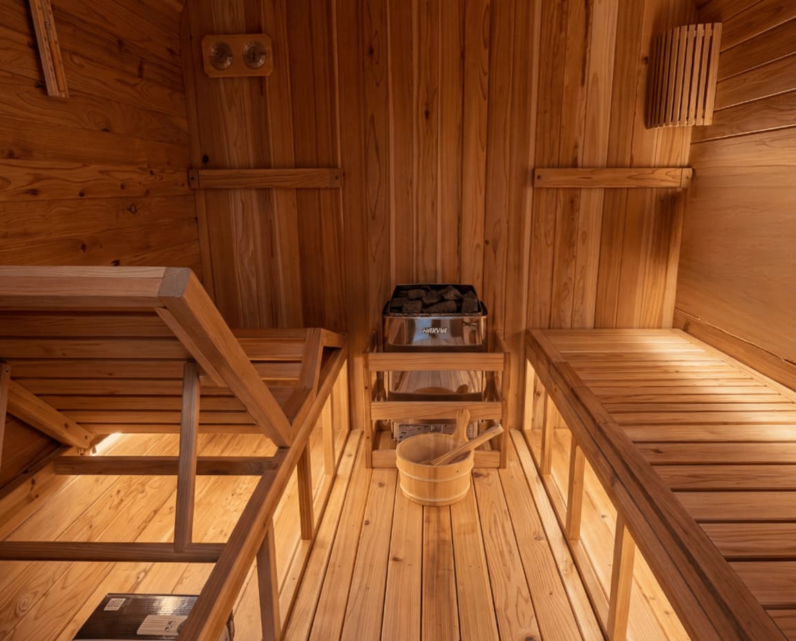 Modern sauna in backyard wellness space with natural lighting and clean design