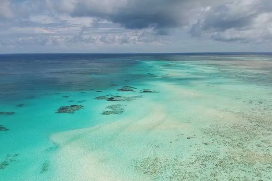 Aerial view of coral reef and sandbanks in the turquoise waters off Zanzibar