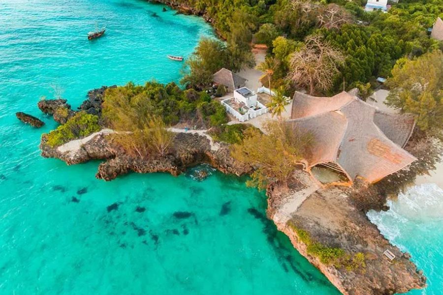Aerial view of a luxury coastal resort surrounded by Zanzibar’s turquoise ocean