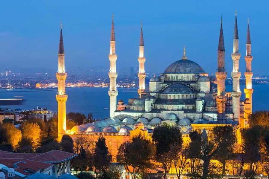 Istanbul’s Blue Mosque illuminated at dusk above the Bosphorus.