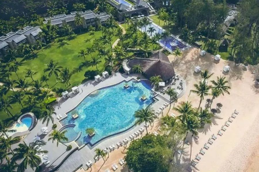 Aerial view of a tropical Mauritius resort with pools and direct beach access.