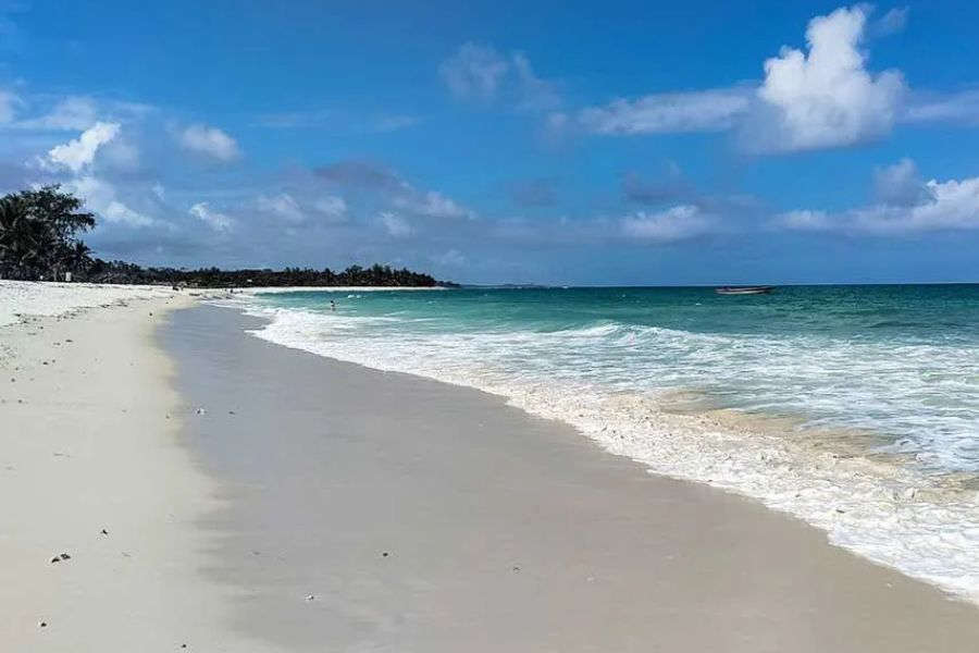 White-sand beach and turquoise ocean on Zanzibar’s tropical coastline.