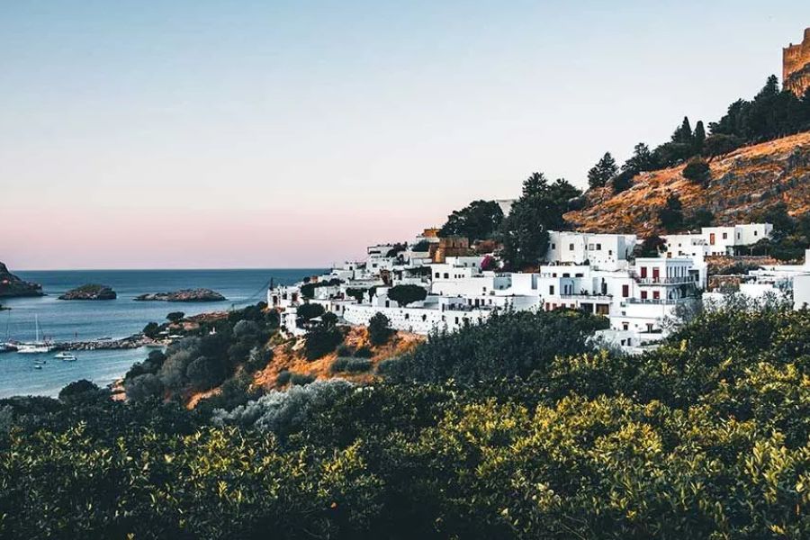 Whitewashed village of Lindos beneath its ancient acropolis in Rhodes.