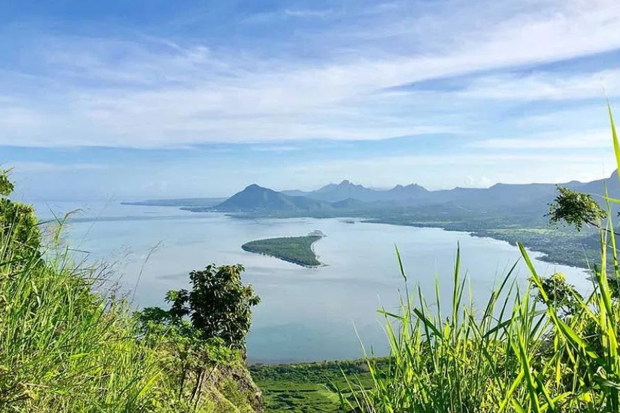 Panoramic mountain and lagoon views from a scenic viewpoint in Mauritius.