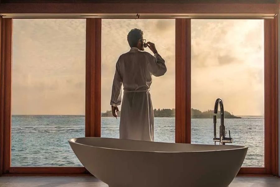 Luxury Maldives villa bathroom with a freestanding bath and ocean view.