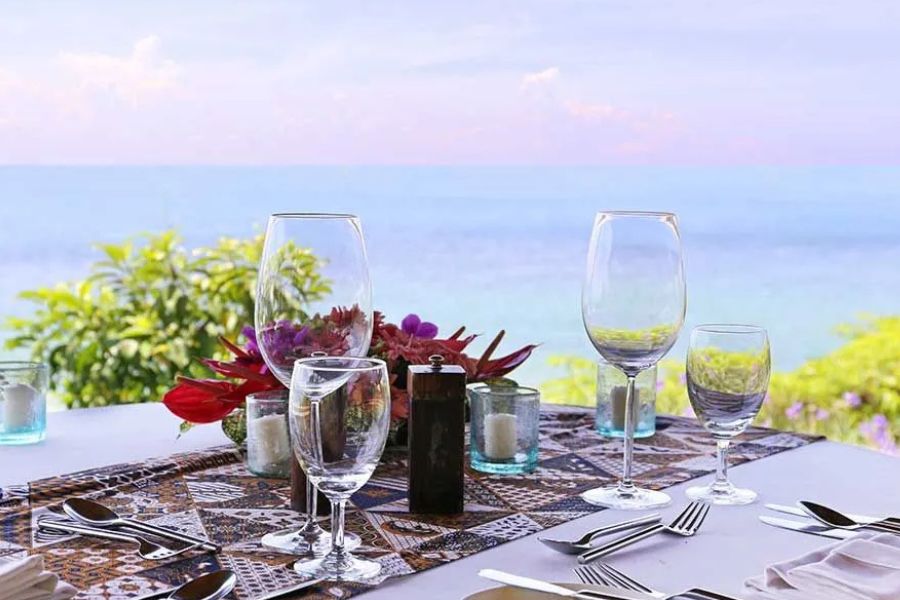 Elegant ocean-view dining setup at a tropical island resort.