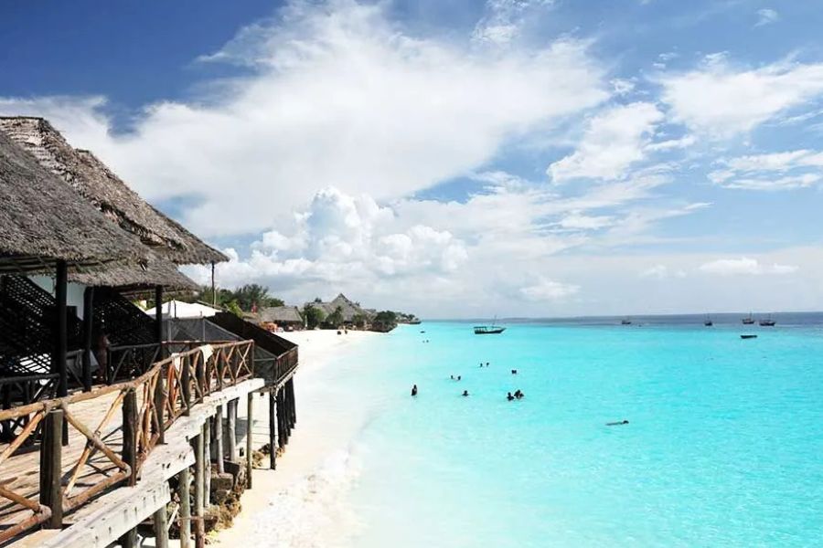 Zanzibar beach resort with white sand and crystal-clear turquoise water.