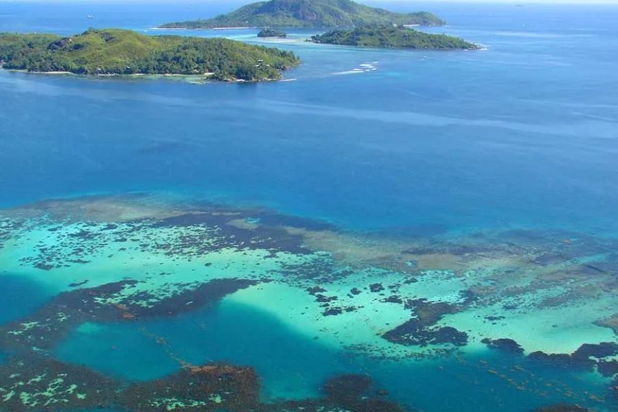 Aerial view of coral reefs and tropical islands in the Seychelles.