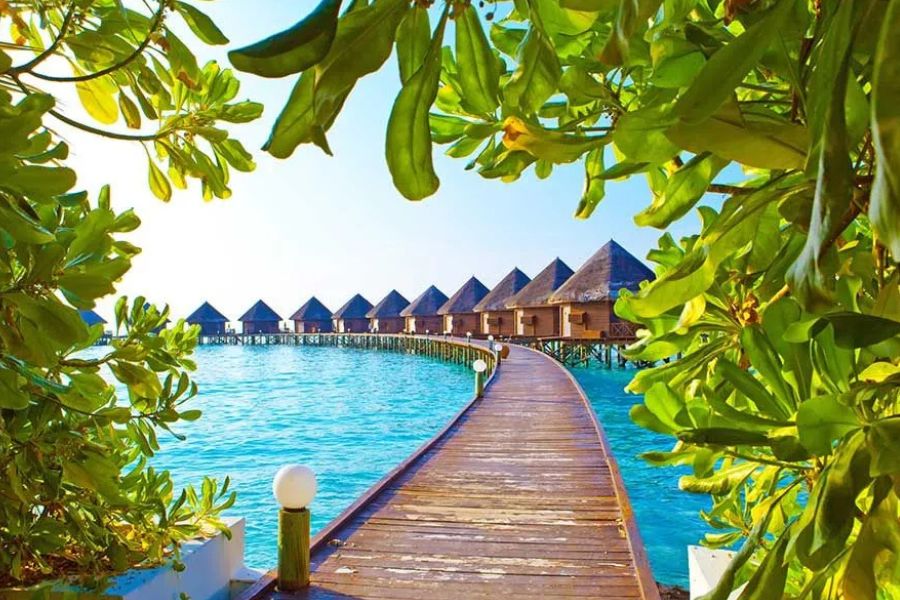 Wooden walkway leading to luxury overwater villas in the Maldives.