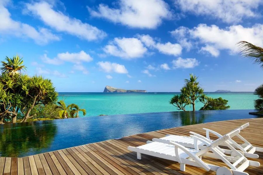 Infinity pool overlooking Coin de Mire and turquoise waters in Mauritius.