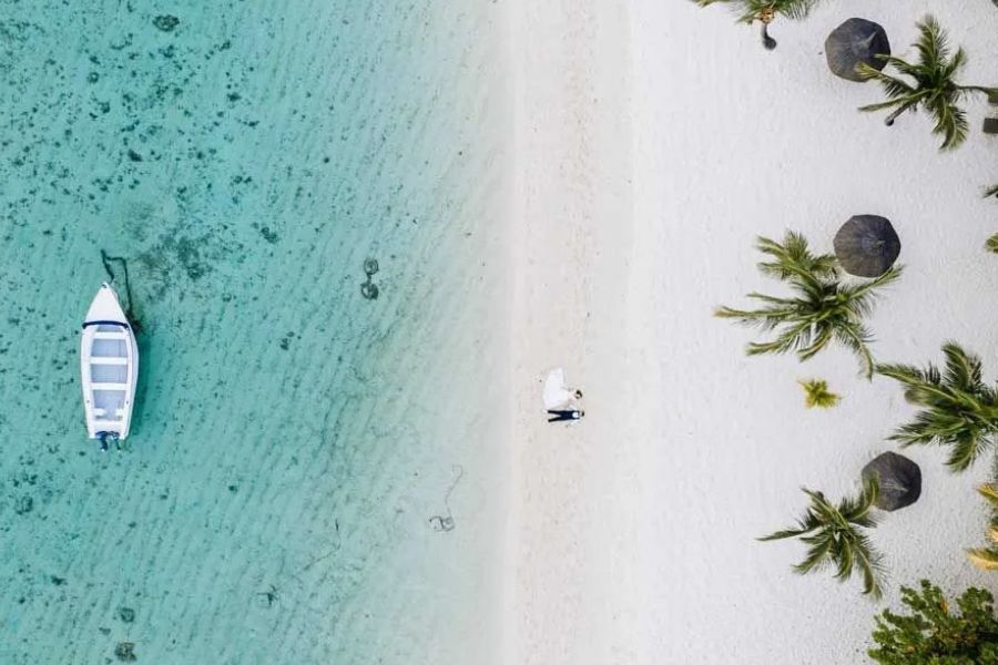 Aerial view of a white-sand beach and clear lagoon in Mauritius.