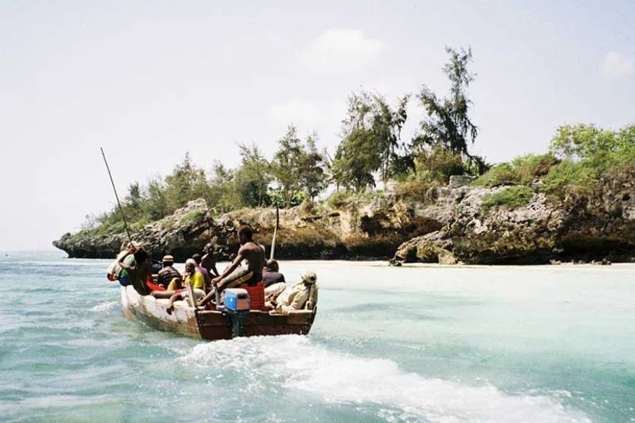 Boat trip through Zanzibar’s turquoise coastal waters and rocky island scenery.