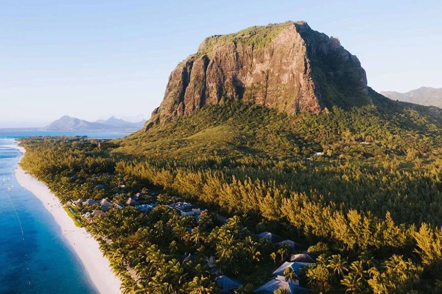 Aerial view of Le Morne Brabant mountain in Mauritius, with beachfront resorts along the sandy shoreline