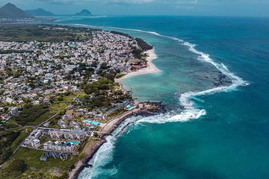 Aerial view of Flic en Flac's coastline in Mauritius, showing beachfront resorts along the reef