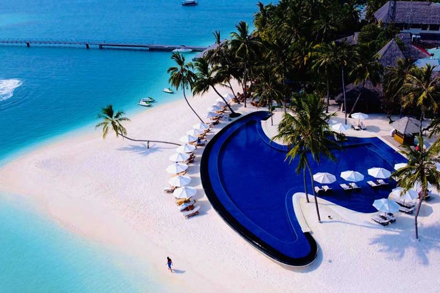Beachfront resort pool in the Maldives