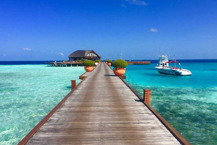 Wooden jetty over clear water in the Maldives