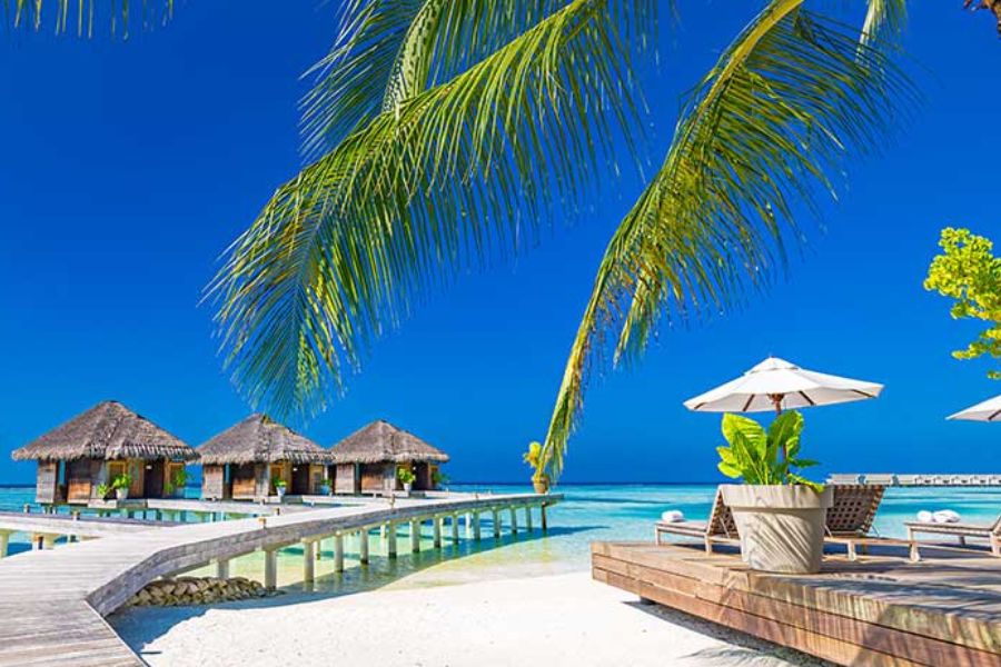Overwater villa in the Maldives at sunset, a popular honeymoon setting