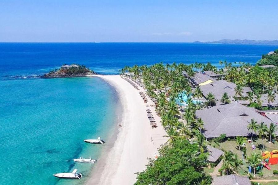 Beach and tropical gardens at VOI Andilana Beach Resort, Andilana, Nosy Be, Madagascar.