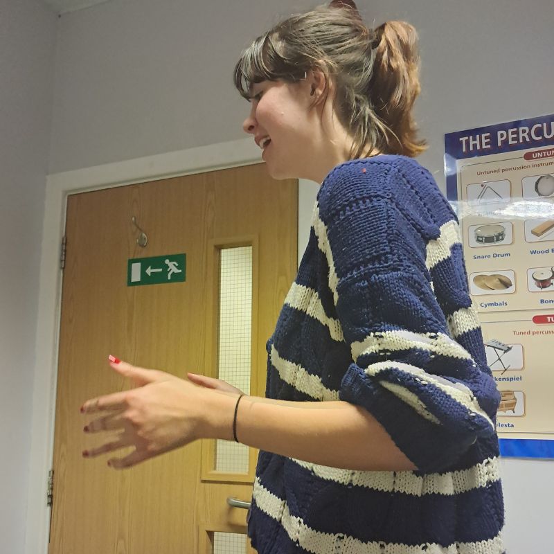 Happy student participating in voice singing lessons