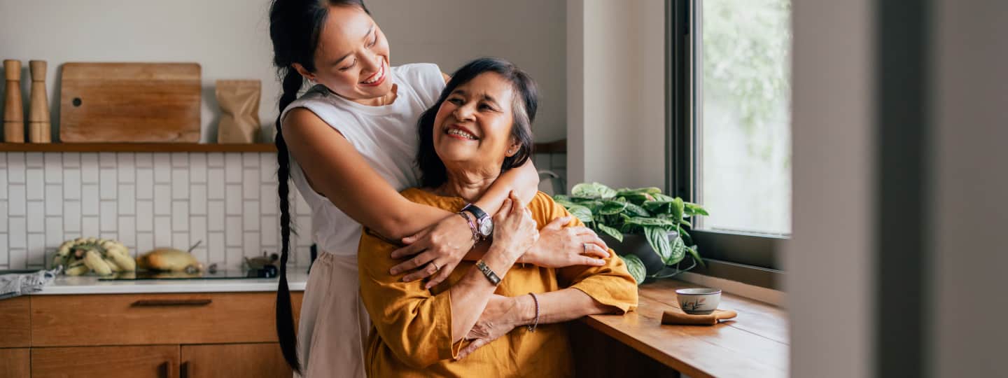 Female caregiver hugging her mother