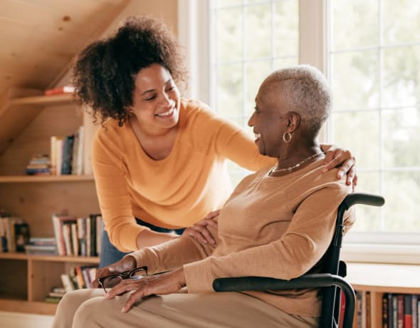 Caregiver with an older woman in a wheelchair