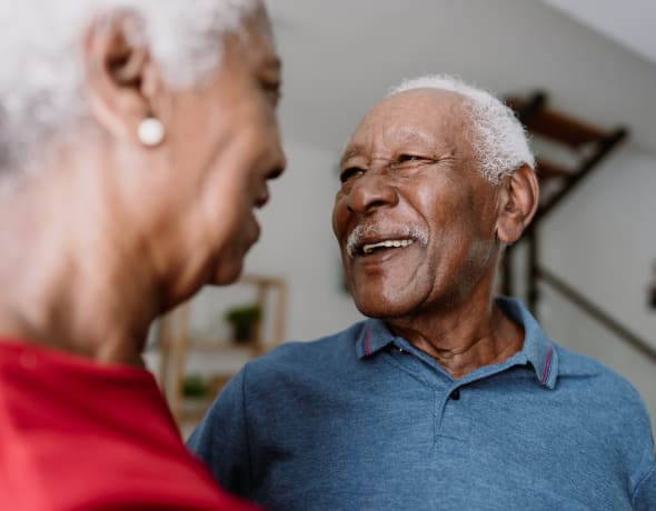 Older man is smiling at his relative caregiver