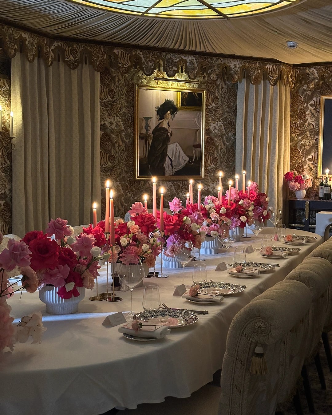 Luxury indoor dining event setup with floral centrepieces, candle décor and elegant table styling