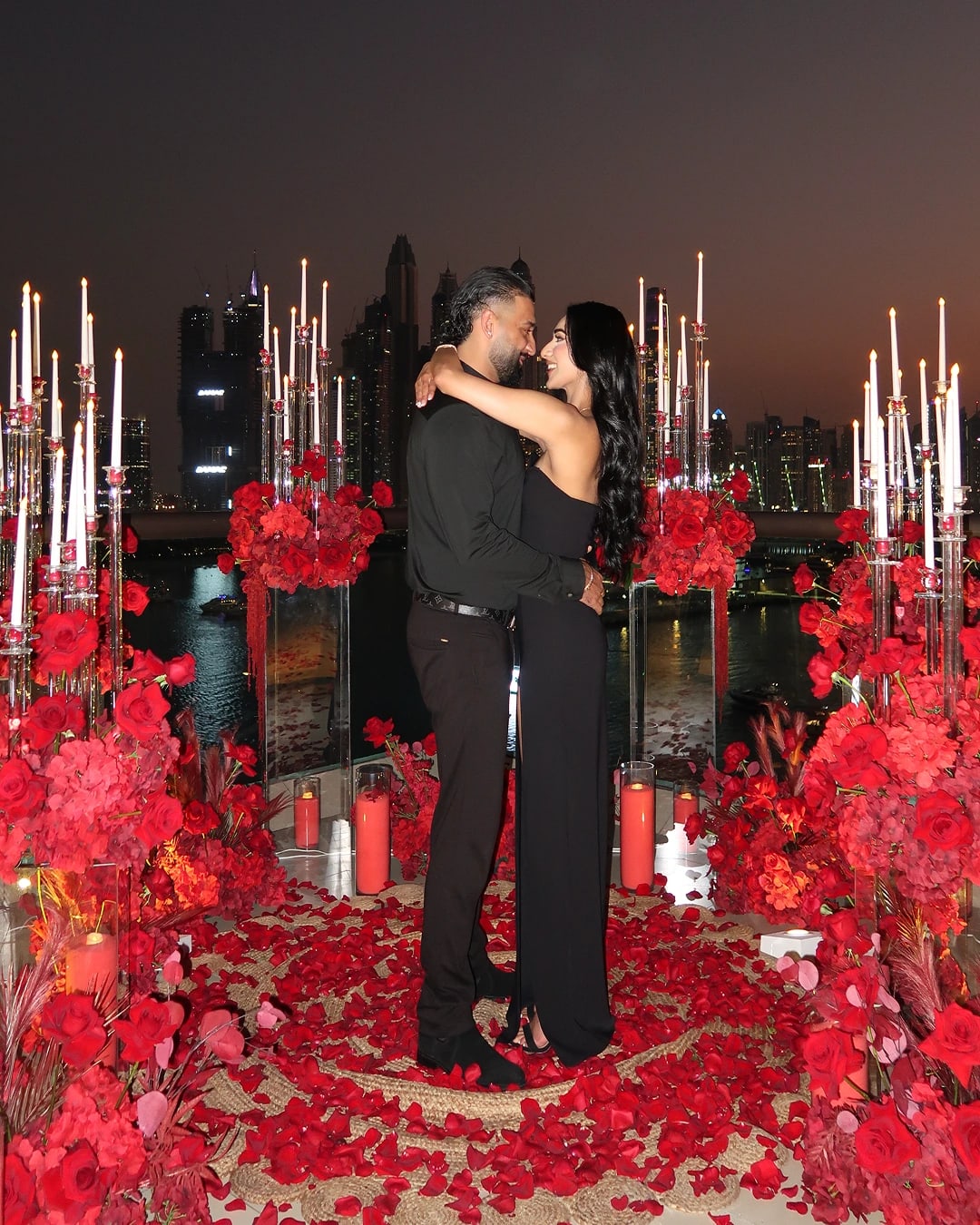 Romantic proposal setup with red roses, candles and luxury décor for a couple celebration in Dubai
