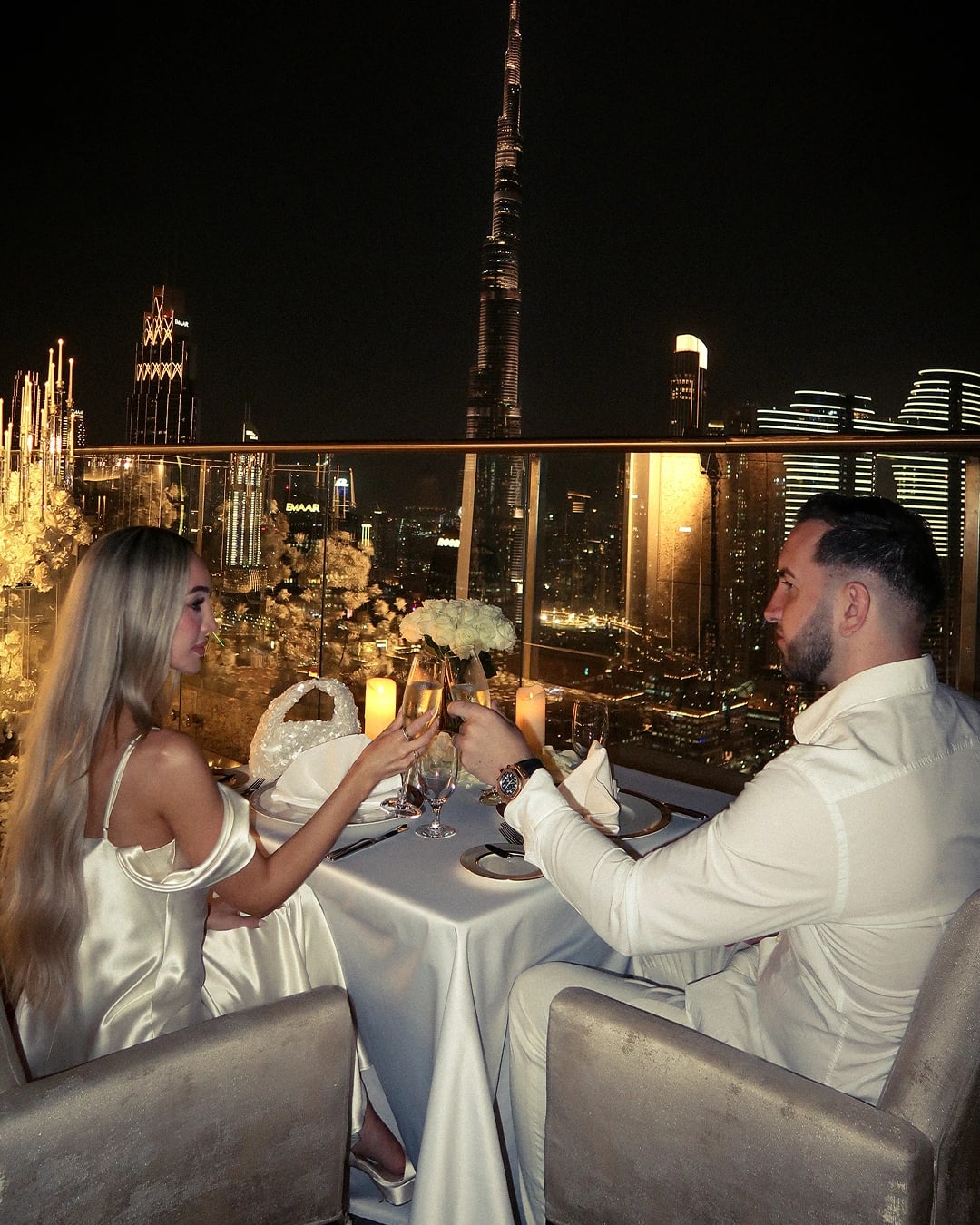 Private rooftop dinner setup with city skyline view, candlelight dining and romantic table décor