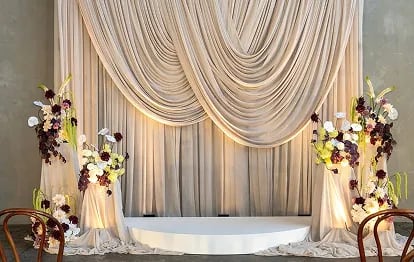 Wedding couple kissing on church steps surrounded by guests