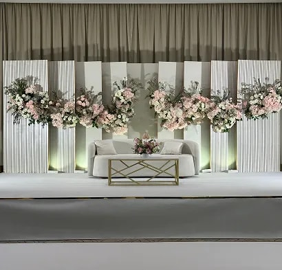 Close-up of couple holding hands in traditional wedding attire with bouquet