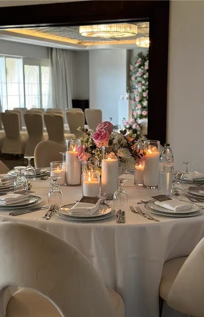 Bridesmaids holding white floral bouquets in blush pink dresses
