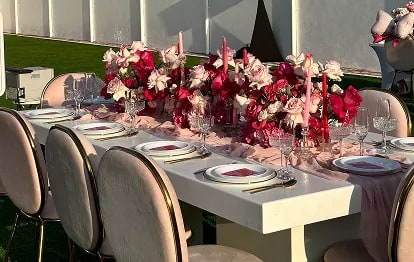 Wedding couple kissing on church steps surrounded by guests