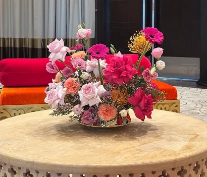 Romantic wedding couple under floral arch setup in outdoor ceremony