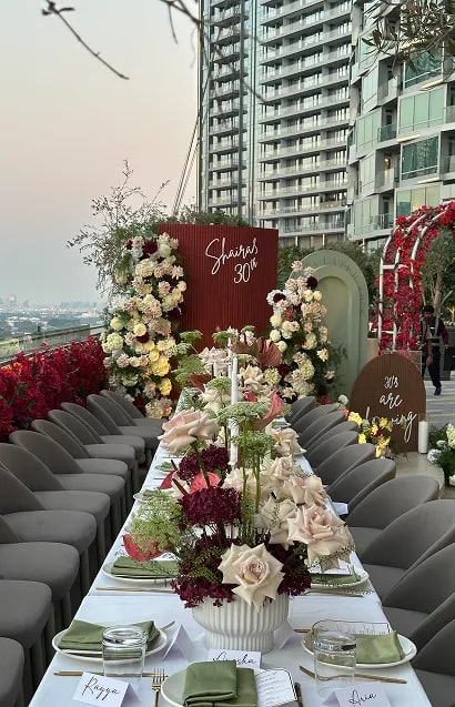 Bridesmaids holding white floral bouquets in blush pink dresses