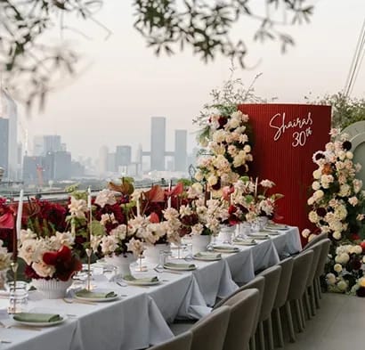 Close-up of couple holding hands in traditional wedding attire with bouquet