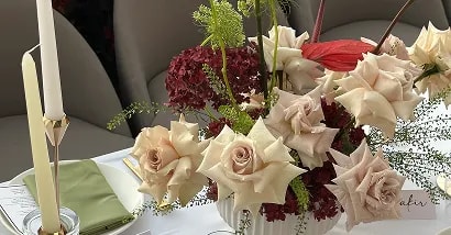 Bride and groom kissing in snow at a winter wedding