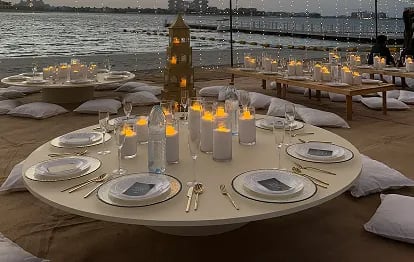 Wedding couple kissing on church steps surrounded by guests