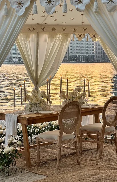 Bridesmaids holding white floral bouquets in blush pink dresses