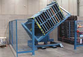 alt with keywords: A shiny, stainless steel pallet inverter in a hygienic food processing facility, showing it's easy to clean.
