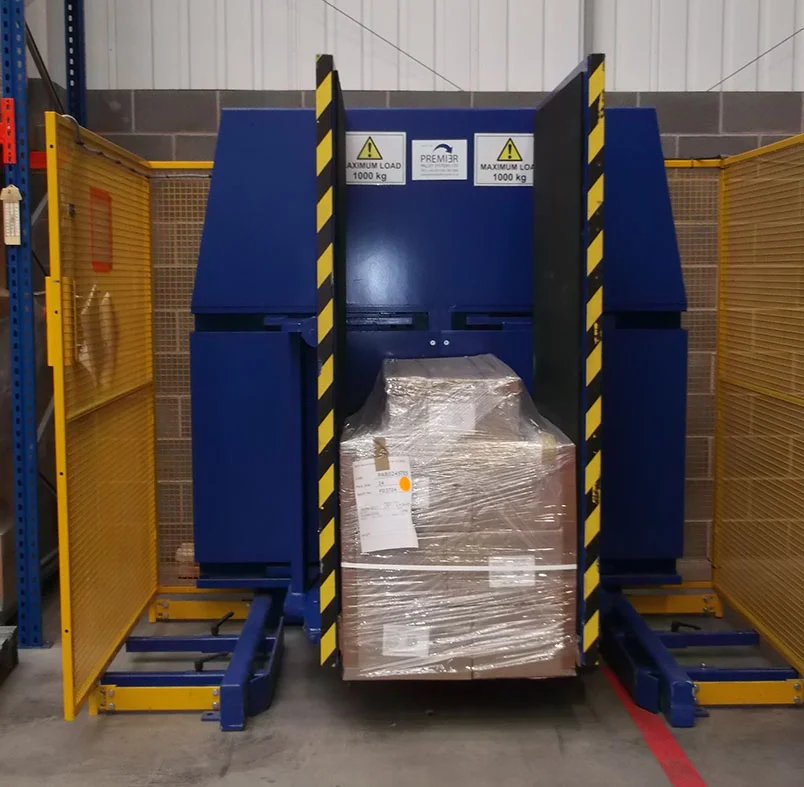 A pallet changer with features for seamless integration into an automated warehouse system