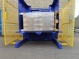 A pallet inverter with safety guarding in a modern warehouse