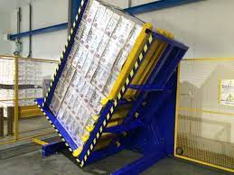 A heavy-duty pallet changer machine in an industrial setting, showcasing its robust construction for handling large loads.