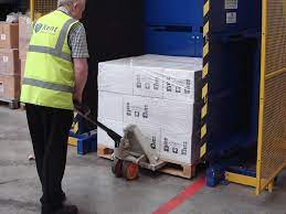 A pallet changer being used for logistics optimization in a large warehouse