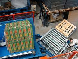 A pallet changer integrated into a larger automated system, showing connectivity.