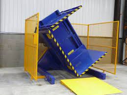 An automated pallet changer machine in a clean warehouse environment, handling a stack of boxes.