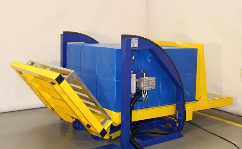 alt with keywords: A pallet inverter in a busy Colombian distribution center, handling a load of boxes.