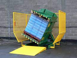 Close-up on safety features of a pallet changer, like light curtains and emergency stops.